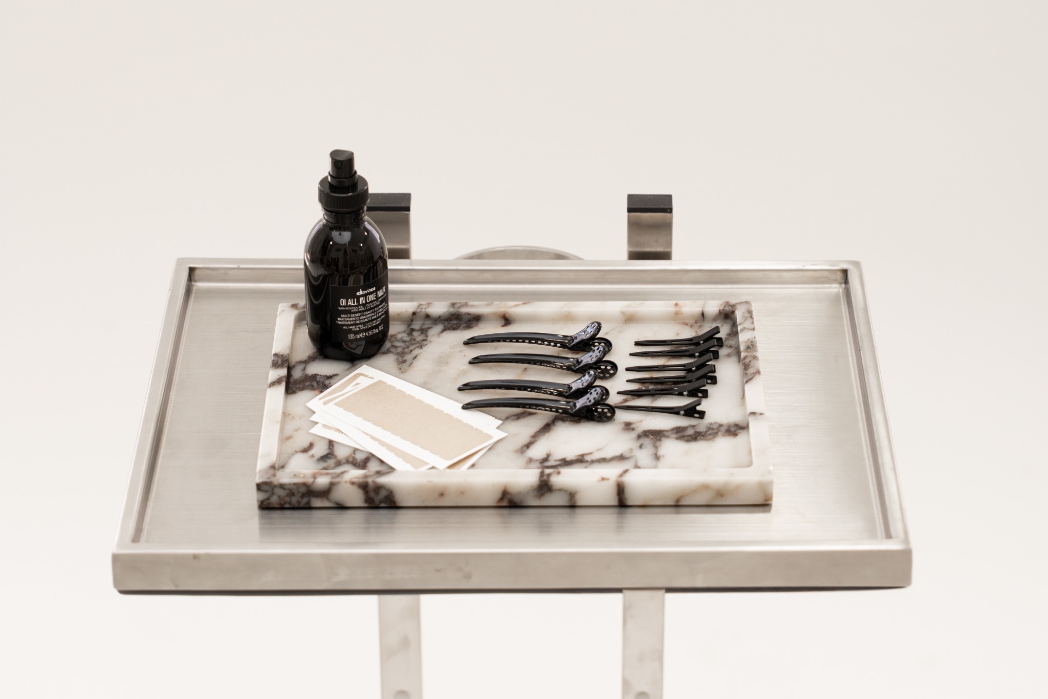 Tape extension supplies with Davines OI on the salon tray